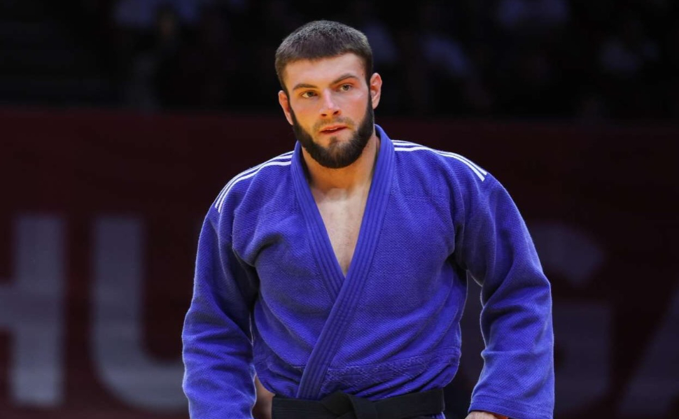 Serbian judoka Boris Rutović wearing a blue judo uniform and black belt during a competition.