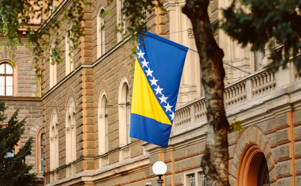 Bosnia and Herzegovina flag displayed on a building, illustrating the Republika Srpska lobbying dispute.