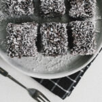 Traditional Yugoslav čupavci chocolate coconut cake squares served on a plate.