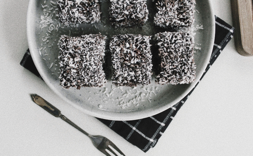 Traditional Yugoslav čupavci chocolate coconut cake squares served on a plate.
