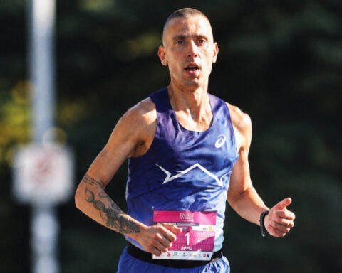 Dario Ivanovski World Championships hopeful running in a road race, wearing a blue athletic jersey and race bib.