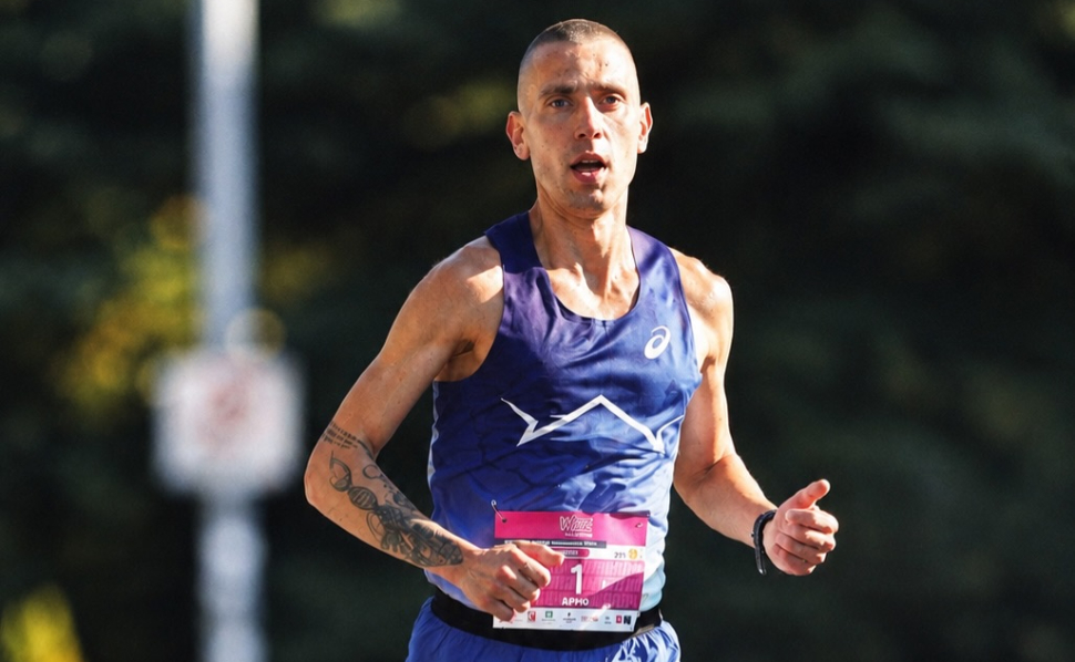 Dario Ivanovski World Championships hopeful running in a road race, wearing a blue athletic jersey and race bib.