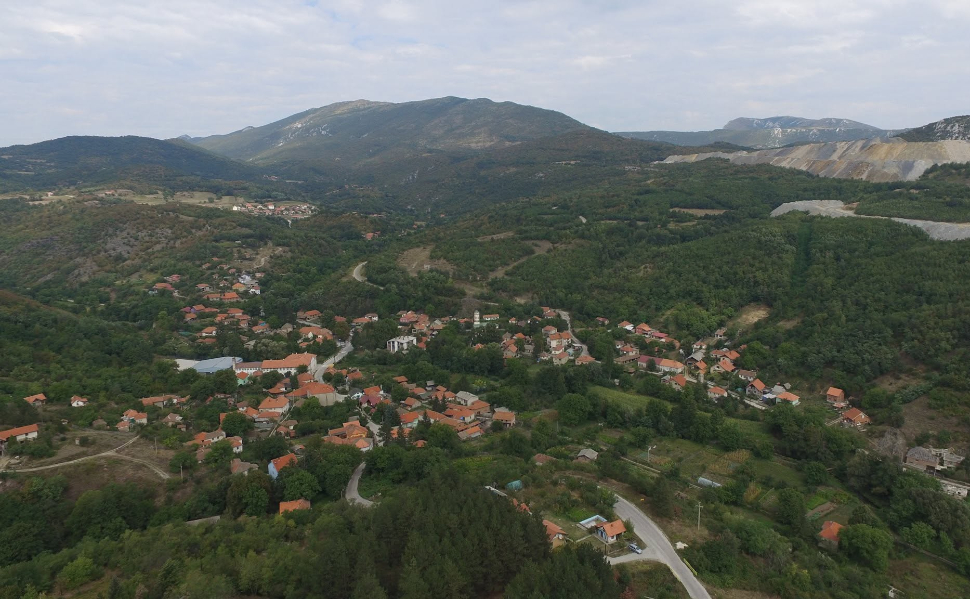 Panoramic view of Krivelj village near Bor, Serbia, with houses, surrounding hills and mining areas in the distance.
