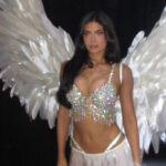 Kylie Jenner wearing a diamond-encrusted Fantasy Bra, large white feathered wings and a white skirt at the Victoria’s Secret Fashion Show 2026.