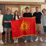 Six young people pose with a Macedonian flag during a Macedonian language and cultural gathering in Melbourne, Australia.