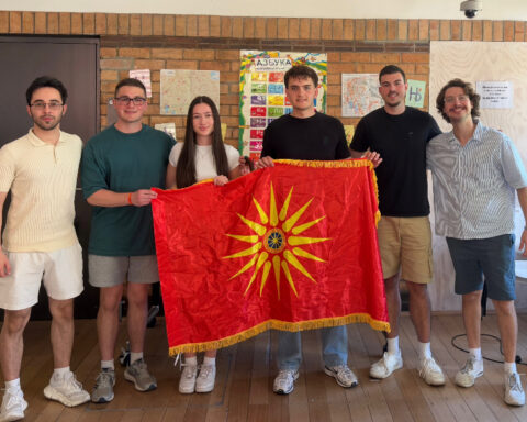 Six young people pose with a Macedonian flag during a Macedonian language and cultural gathering in Melbourne, Australia.