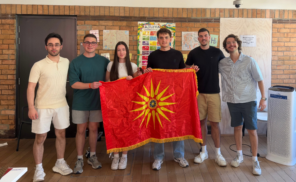 Six young people pose with a Macedonian flag during a Macedonian language and cultural gathering in Melbourne, Australia.
