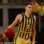 Macedonian basketball player Nenad Dimitrijevic dribbling the ball in an Aris Thessaloniki jersey during a EuroCup game.