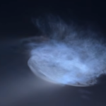 Space jellyfish glowing in the night sky after a SpaceX Falcon 9 rocket launch, creating a bright blue cloud.