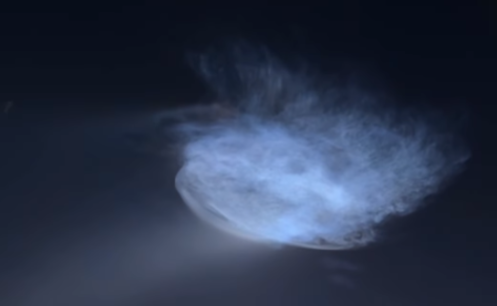 Space jellyfish glowing in the night sky after a SpaceX Falcon 9 rocket launch, creating a bright blue cloud.