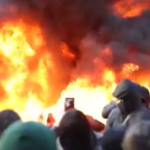 Large flames and thick smoke rise as protesters gather during anti-government demonstrations in Tirana, Albania.