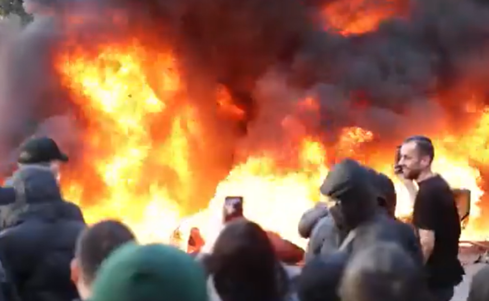 Large flames and thick smoke rise as protesters gather during anti-government demonstrations in Tirana, Albania.