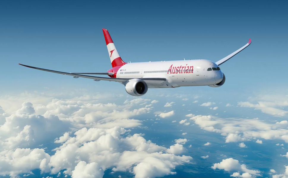 Austrian Airlines passenger aircraft flying above the clouds.