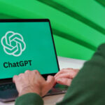 Person using a laptop displaying the ChatGPT logo, the artificial intelligence chatbot developed by OpenAI.