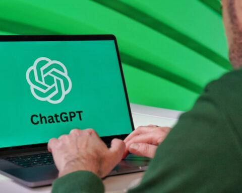 Person using a laptop displaying the ChatGPT logo, the artificial intelligence chatbot developed by OpenAI.