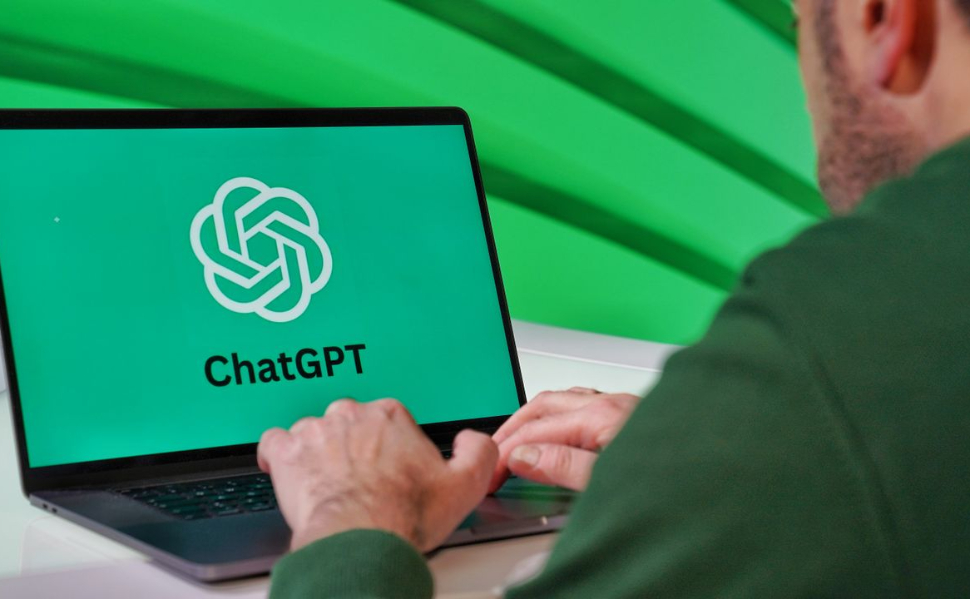 Person using a laptop displaying the ChatGPT logo, the artificial intelligence chatbot developed by OpenAI.