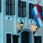 Croatian and European Union flags illustrating the Croatia Montenegro EU membership negotiations.