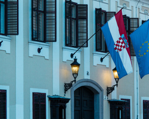 Croatian and European Union flags illustrating the Croatia Montenegro EU membership negotiations.