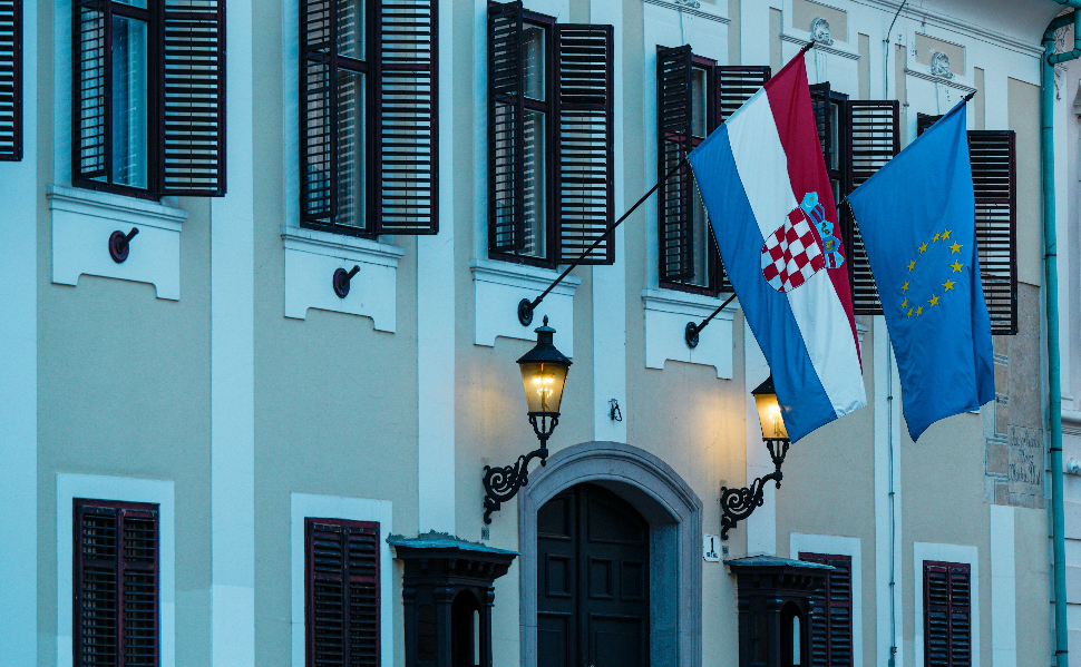 Croatian and European Union flags illustrating the Croatia Montenegro EU membership negotiations.