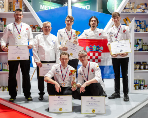 Croatian chefs displaying their medals, trophies and certificates at the Global Chefs Challenge competition in Belgrade.