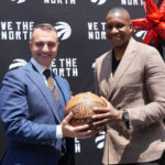 Serbian basketball coach Darko Rajaković posing with Toronto Raptors president Masai Ujiri while holding a basketball.