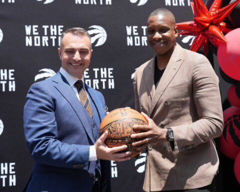 Serbian basketball coach Darko Rajaković posing with Toronto Raptors president Masai Ujiri while holding a basketball.