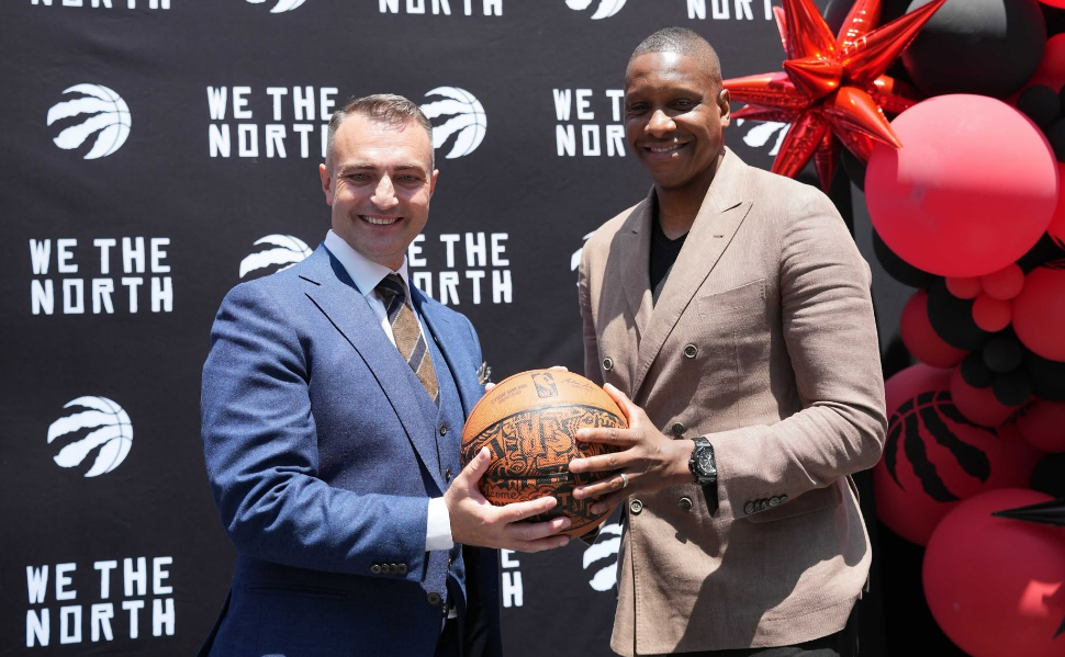 Serbian basketball coach Darko Rajaković posing with Toronto Raptors president Masai Ujiri while holding a basketball.