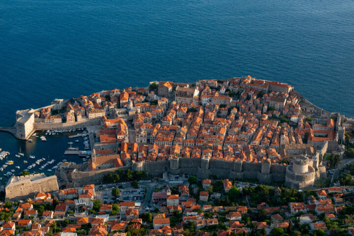 Aerial view of Dubrovnik's historic Old Town, medieval city walls, red rooftops and the Adriatic Sea in Croatia.