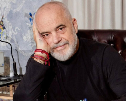 Albanian Prime Minister Edi Rama sitting in his office, resting his head on his hand.