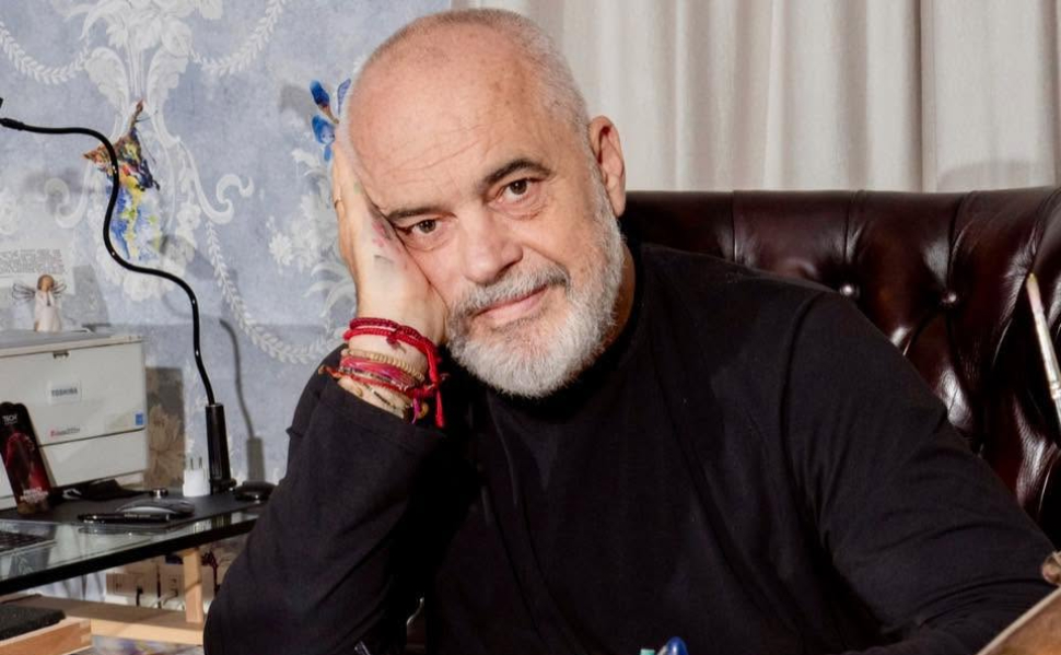 Albanian Prime Minister Edi Rama sitting in his office, resting his head on his hand.