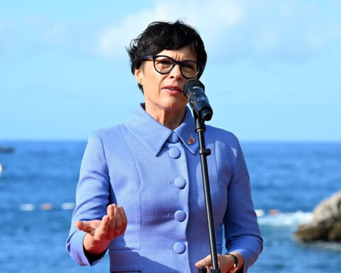 European Commissioner for Enlargement Marta Kos speaking at a podium with the European Union flag in the background.