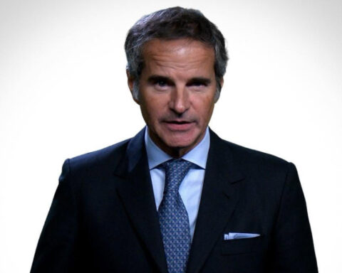 IAEA Director General Rafael Grossi wearing a dark suit and blue tie against a white background.