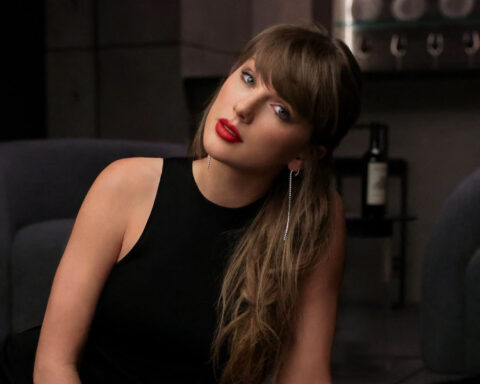 Taylor Swift wearing a black sleeveless dress in an official portrait shared on her Facebook page.