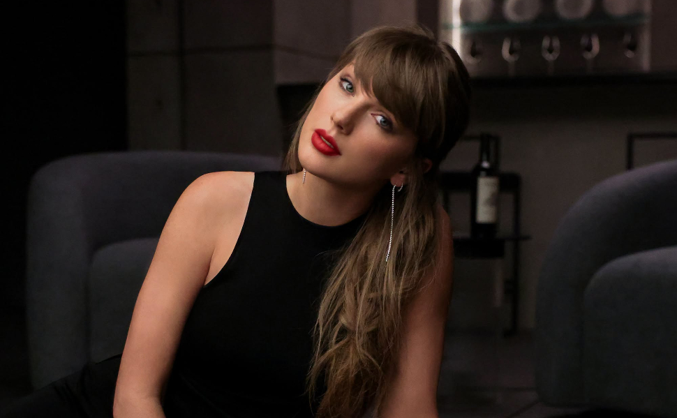 Taylor Swift wearing a black sleeveless dress in an official portrait shared on her Facebook page.
