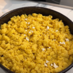 Traditional Macedonian kachamak made from yellow cornmeal and topped with crumbled white cheese.