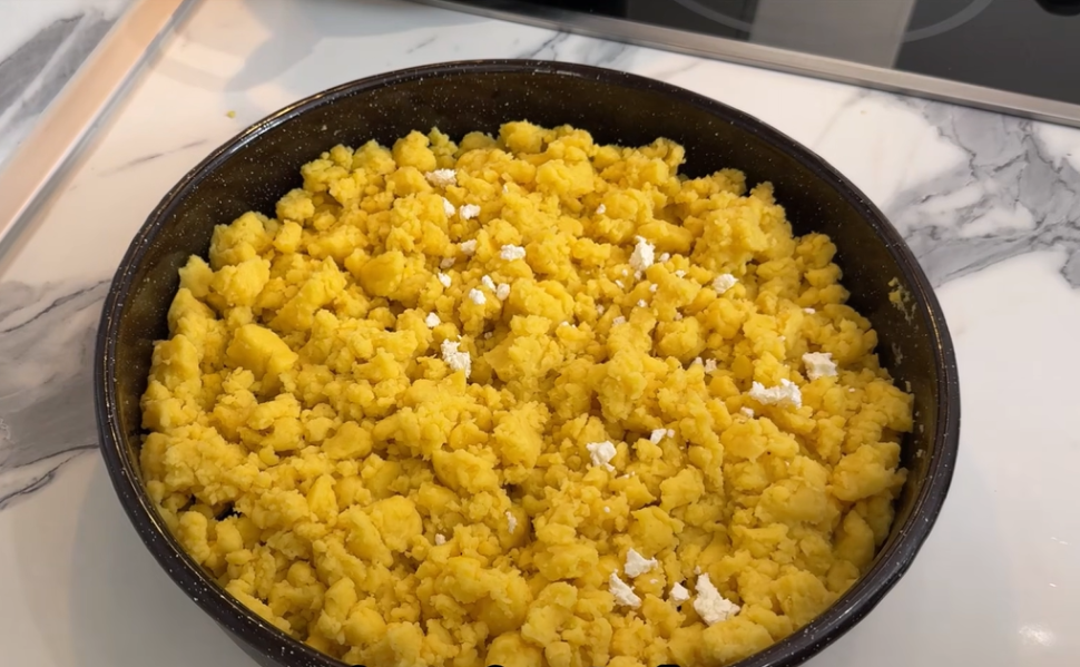 Traditional Macedonian kachamak made from yellow cornmeal and topped with crumbled white cheese.