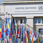 International flags, including the flag of Bosnia and Herzegovina, outside a United Nations building.